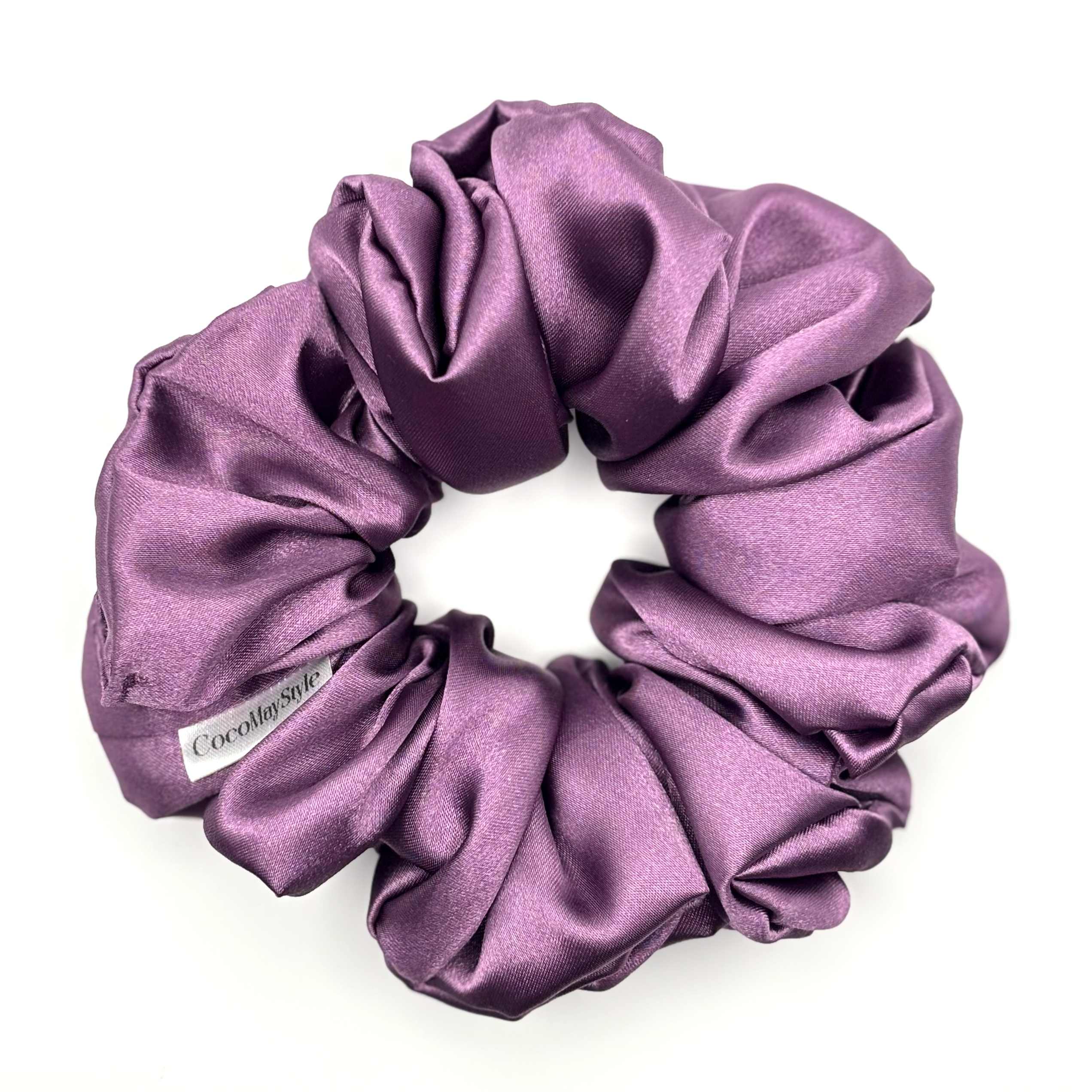 Purple satin scrunchie on a white background