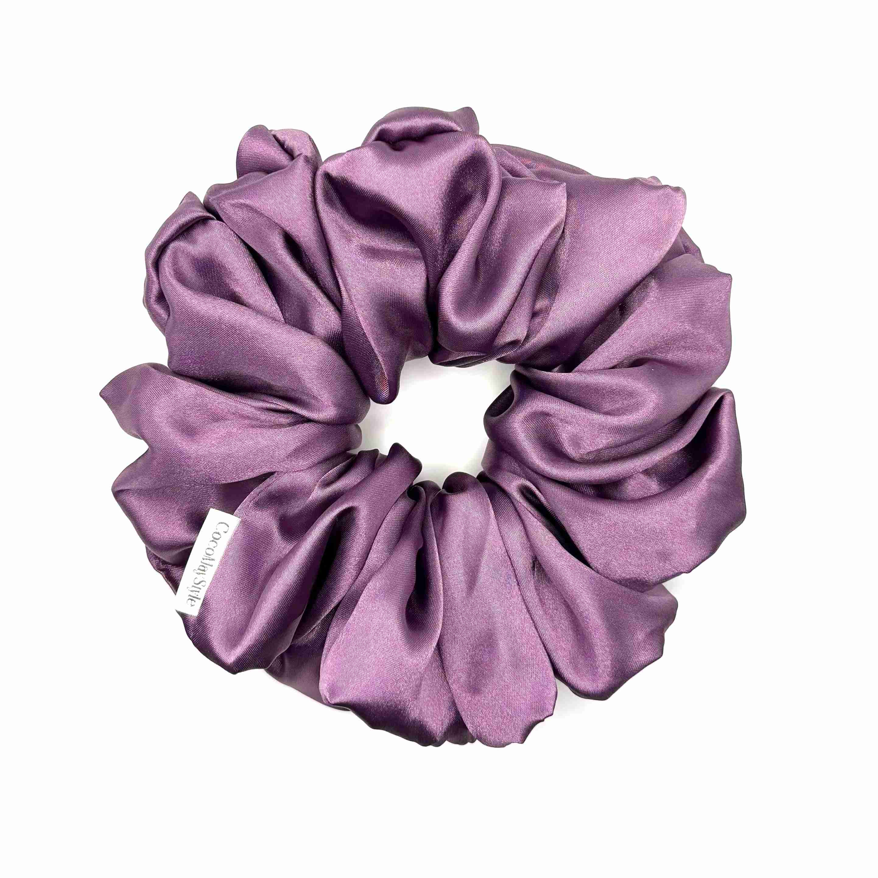 Purple satin scrunchie on a white background