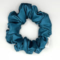 Blue satin scrunchie on a white background