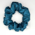 Blue satin scrunchie on a white background