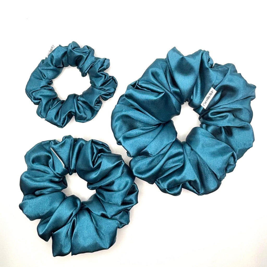 Blue satin scrunchies on a white background