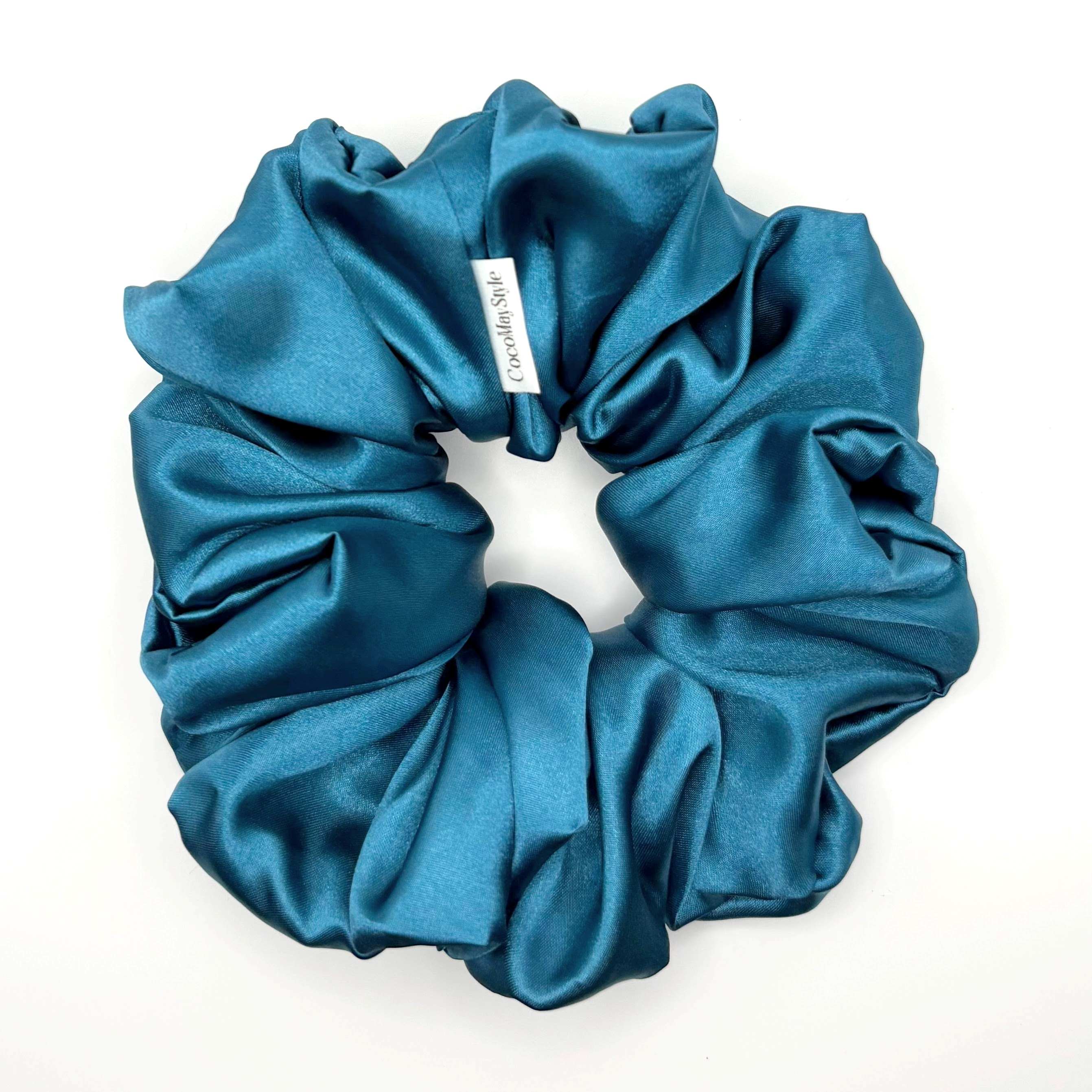 Blue satin scrunchie on a white background