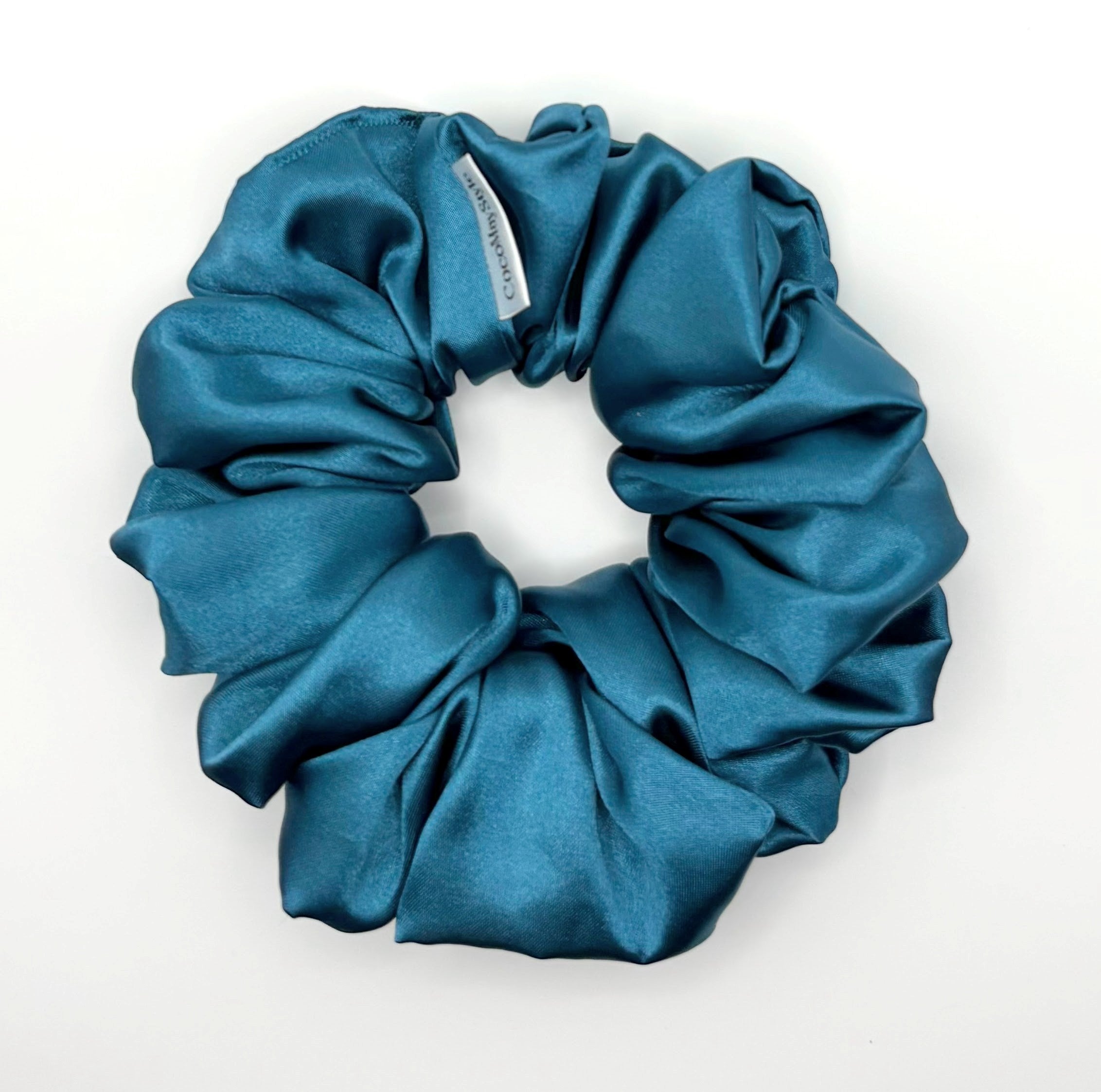 Blue satin scrunchie on a white background
