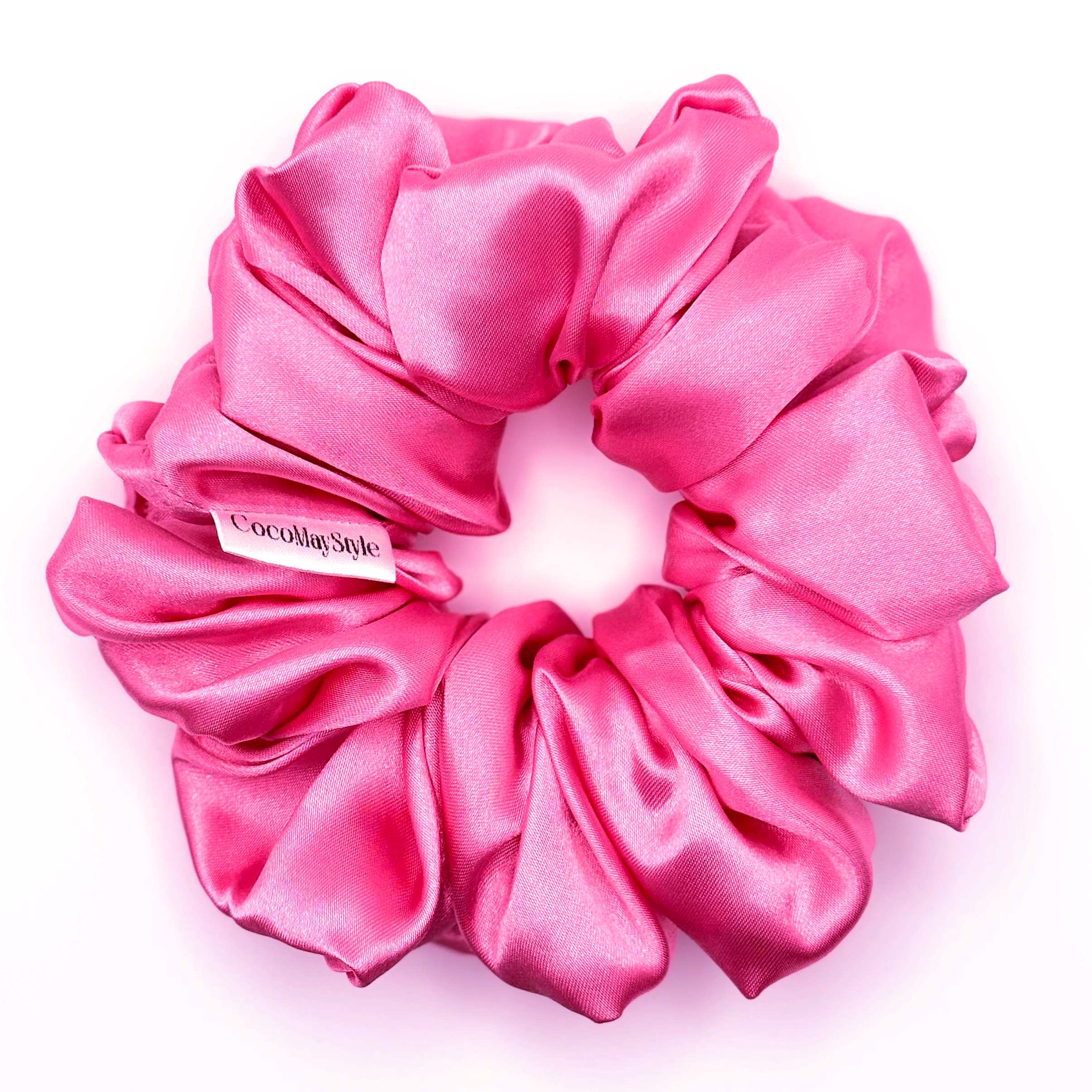 Hot pink satin scrunchie on a white background
