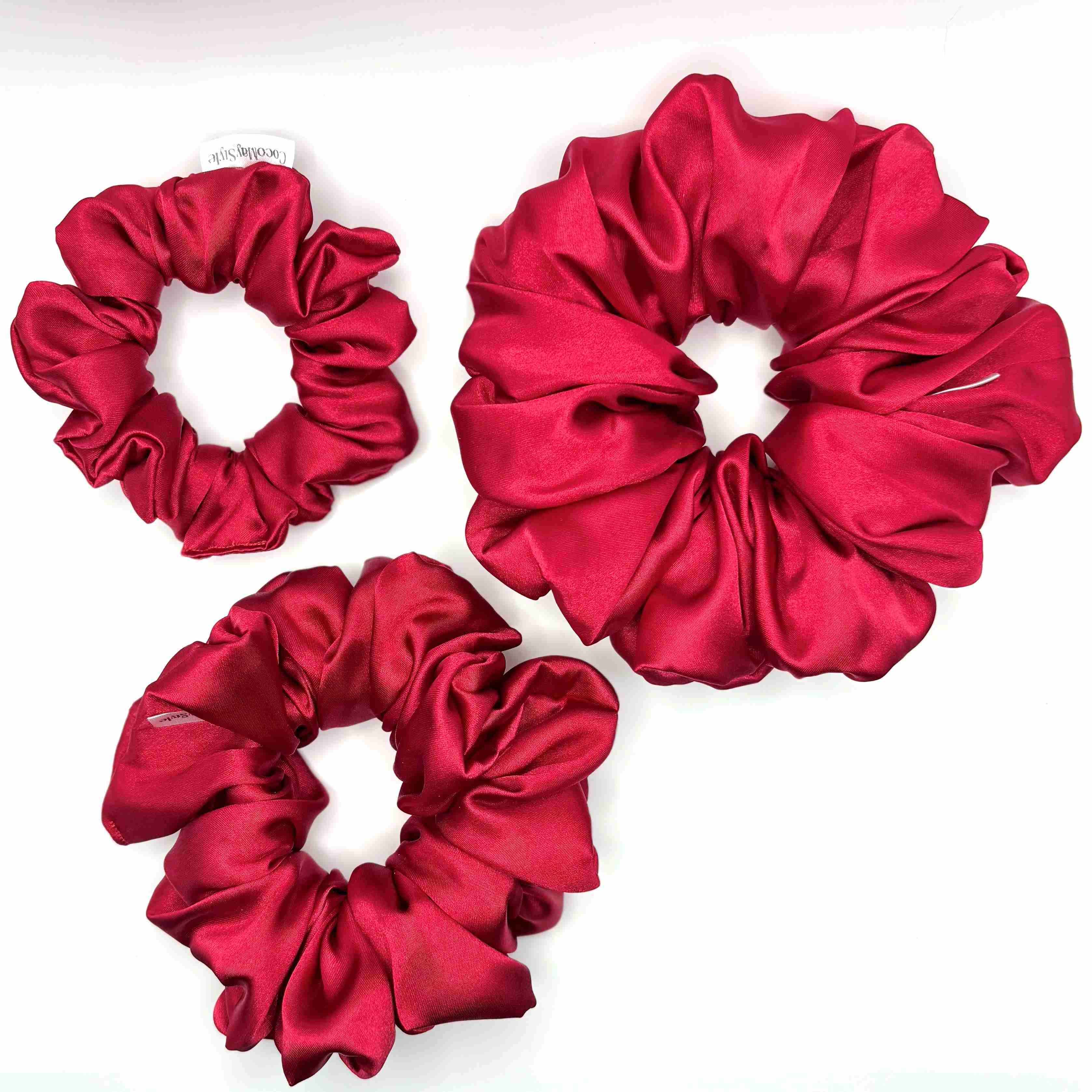 Red satin scrunchies on a white background