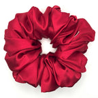 Red satin scrunchie on a white background