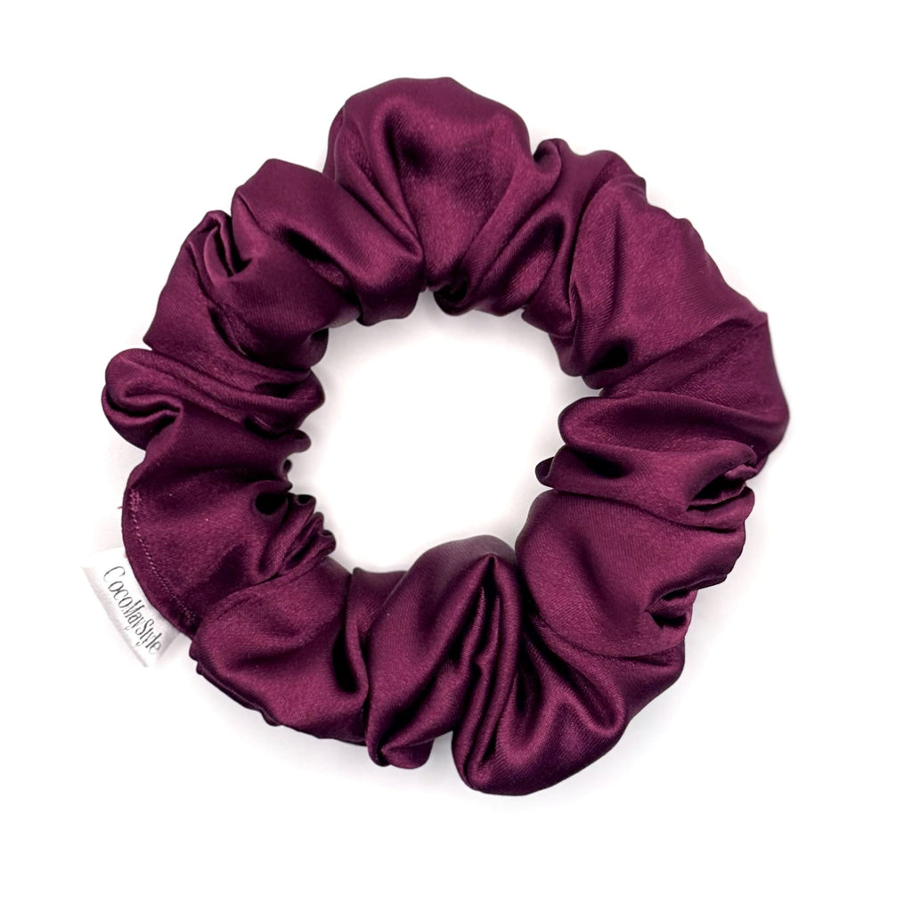 Purple satin scrunchie on a white background