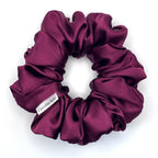 Purple satin scrunchie on a white background