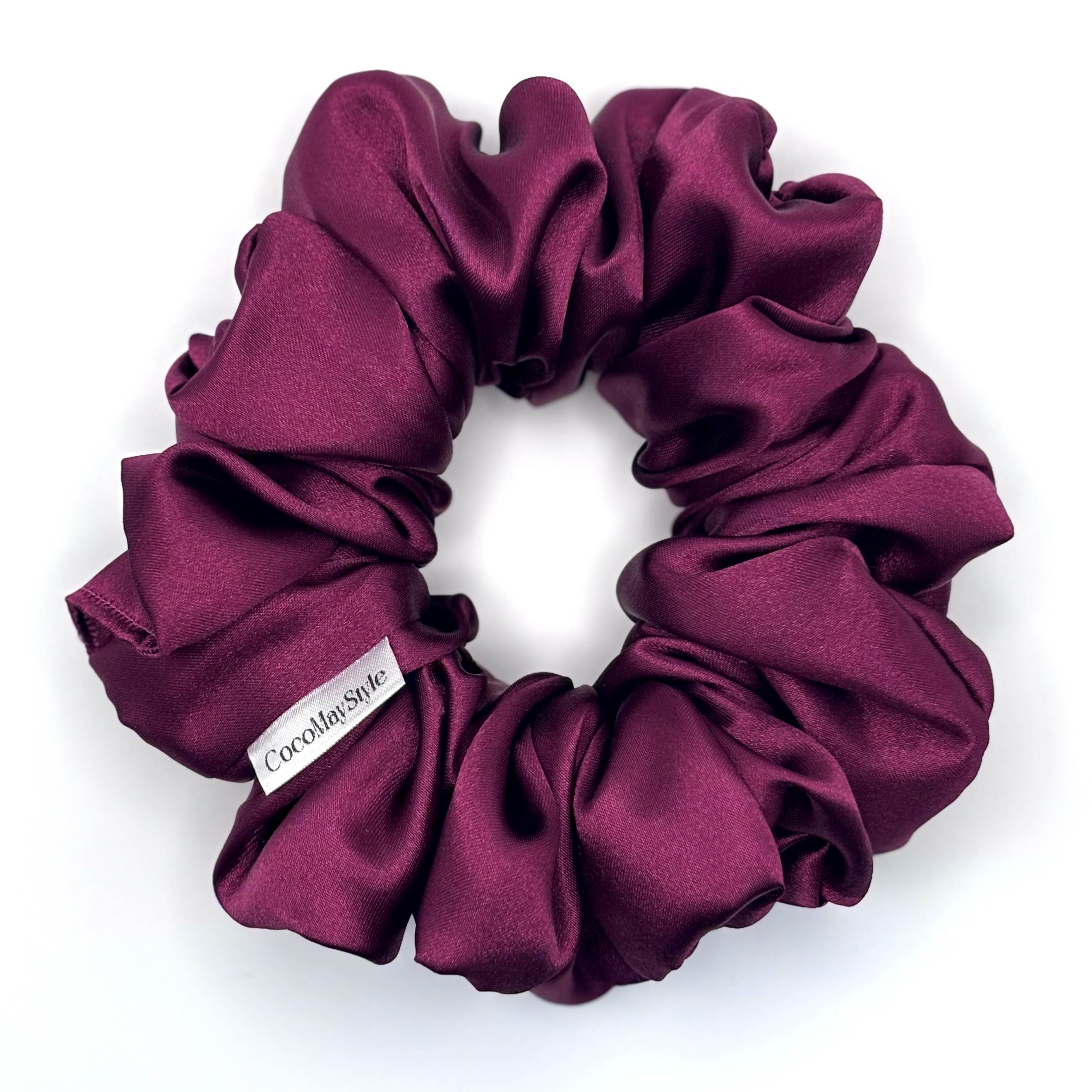 Purple satin scrunchie on a white background