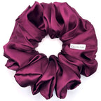 Purple satin scrunchie on a white background