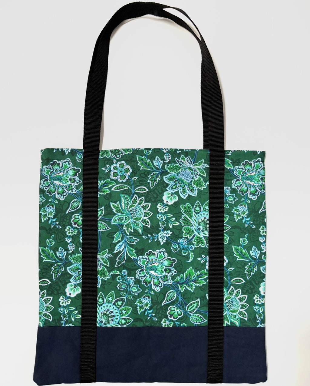 Tote bag with green floral pattern, with dark blue bottom and black bag straps