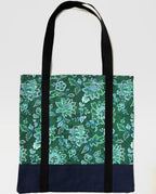 Tote bag with green floral pattern, with dark blue bottom and black bag straps