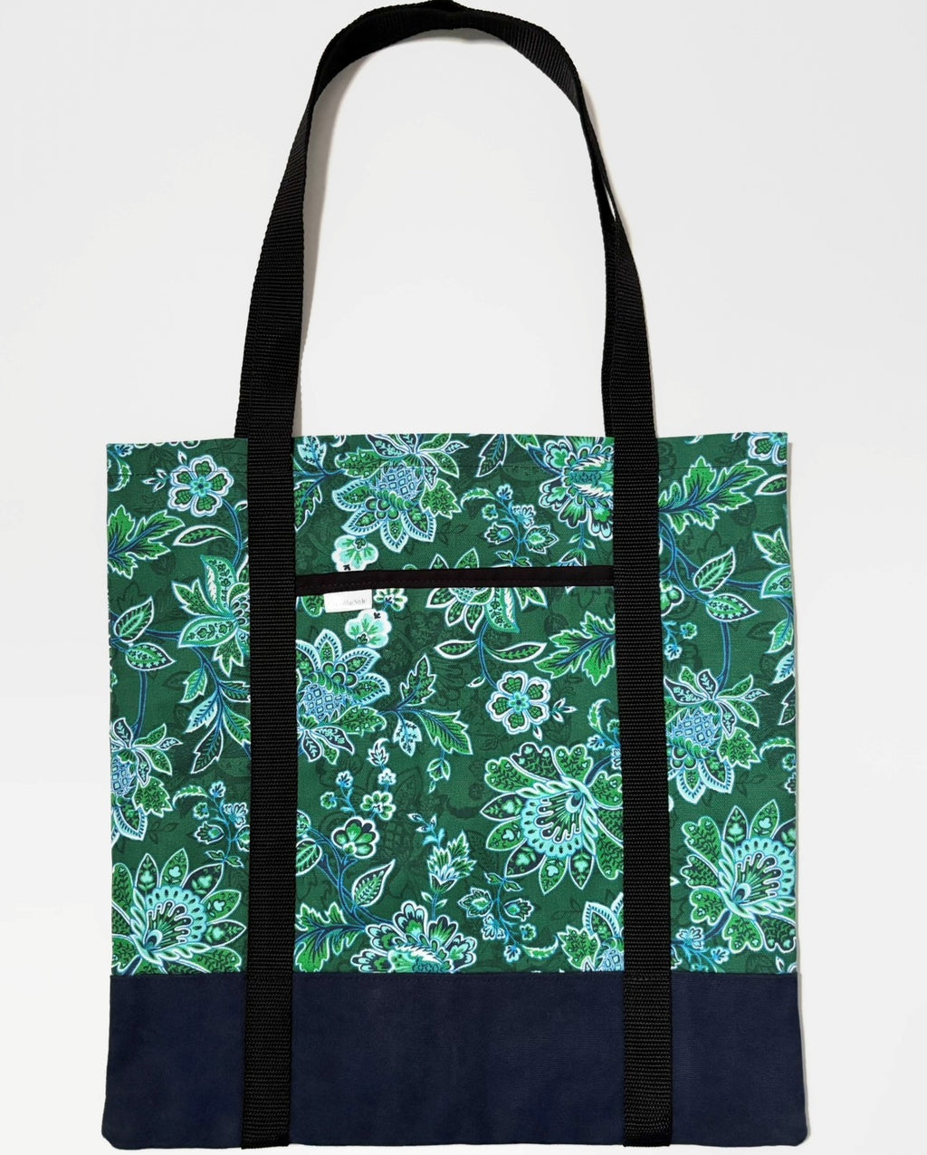 Tote bag with green floral pattern, with dark blue bottom and black bag straps