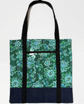 Tote bag with green floral pattern, with dark blue bottom and black bag straps
