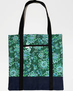 Tote bag with green floral pattern, with dark blue bottom and black bag straps