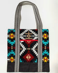 Tote bag with colorful geometric pattern, with black bottom and black and white chevron pattern bag straps