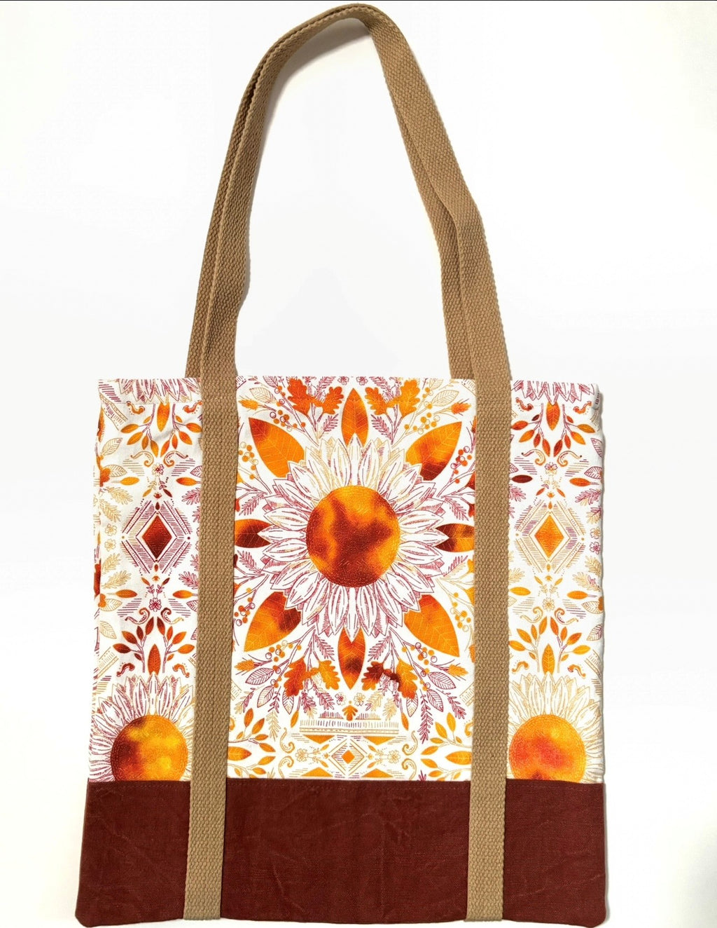 Tote bag with colorful floral pattern, with rusty brown bottom and light brown bag straps