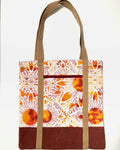 Tote bag with colorful floral pattern, with rusty brown bottom and light brown bag straps