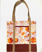 Tote bag with colorful floral pattern, with rusty brown bottom and light brown bag straps
