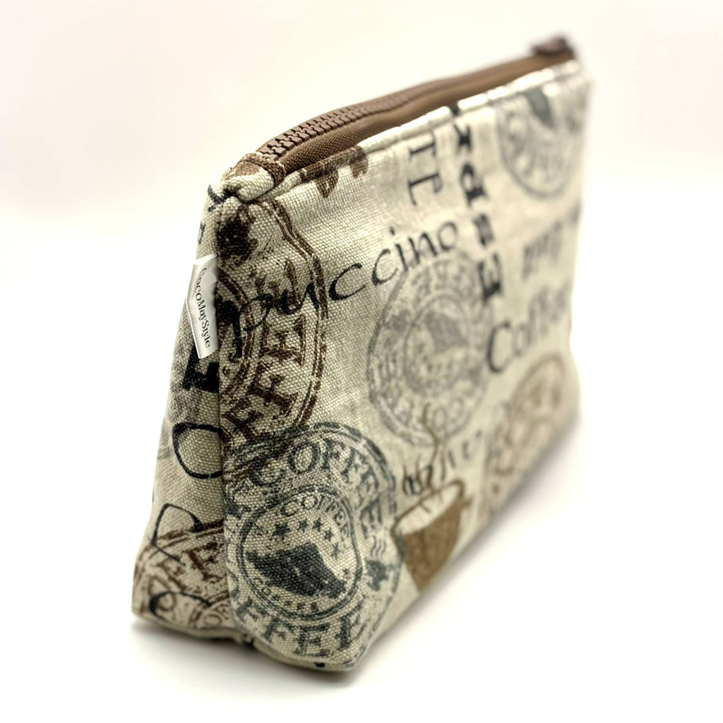 Zipper pouch with coffee words and graphics on a tan brown background