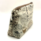 Zipper pouch with coffee words and graphics on a tan brown background