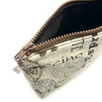 Zipper pouch with coffee words and graphics on a tan brown background