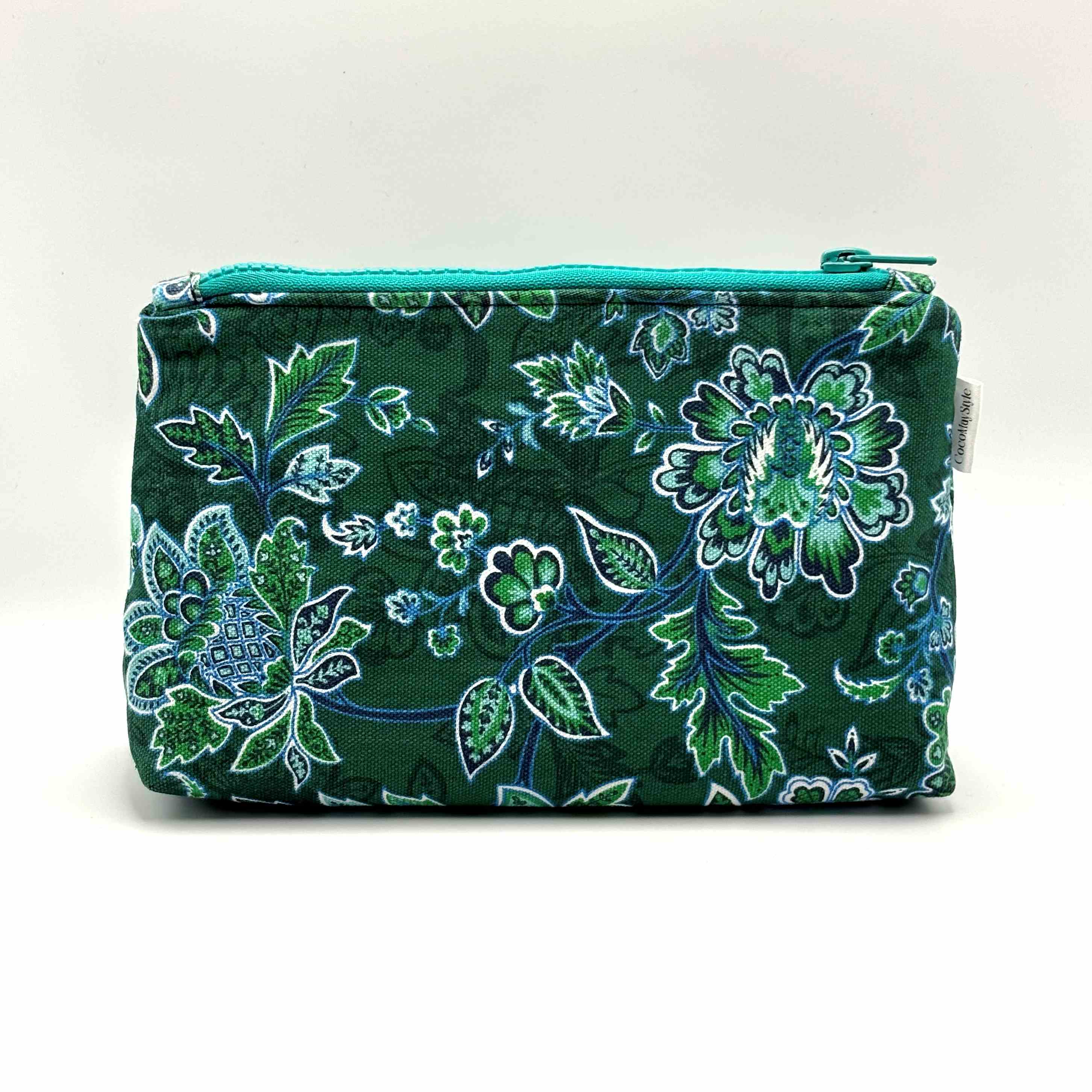 Zipper pouch with green floral pattern on a dark green background