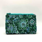 Zipper pouch with green floral pattern on a dark green background