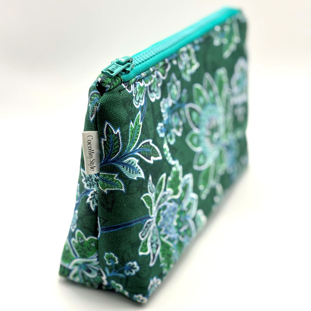Zipper pouch with green floral pattern on a dark green background