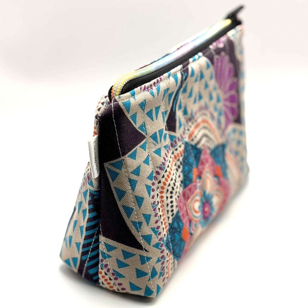 Zipper pouch with a colorful mandala pattern on a dark blue background