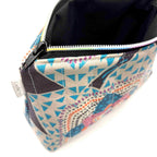 Zipper pouch with a colorful mandala pattern on a dark blue background