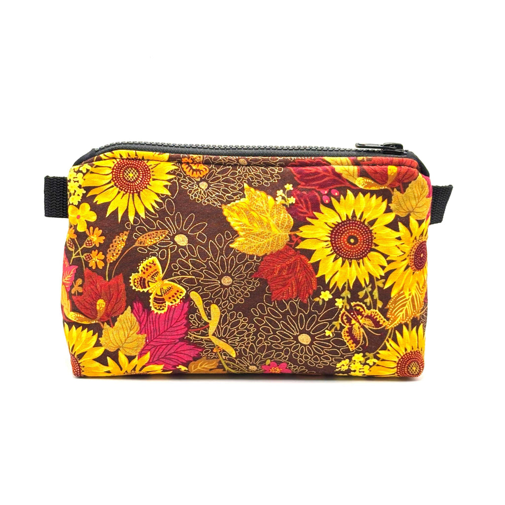 Zipper pouch with yellow florals on a brown background