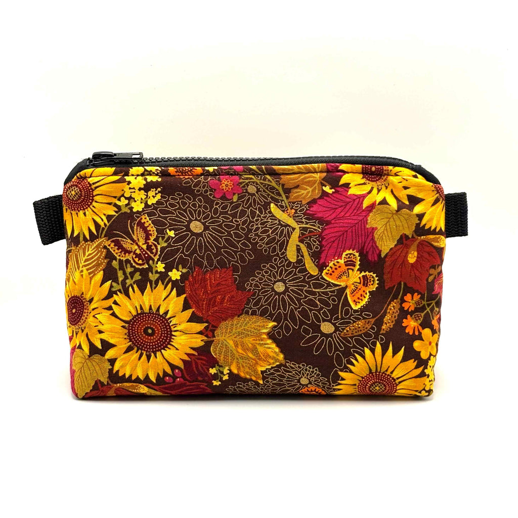Zipper pouch with yellow florals on a brown background