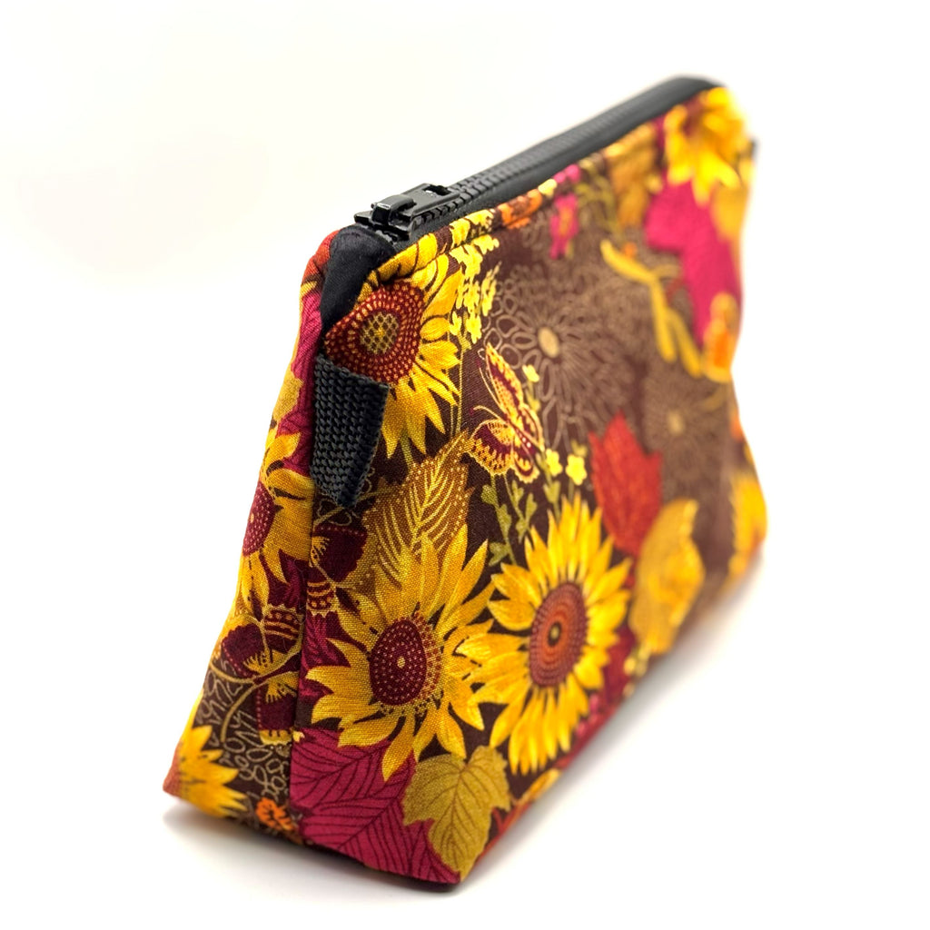 Zipper pouch with yellow florals on a brown background