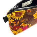 Zipper pouch with yellow florals on a brown background