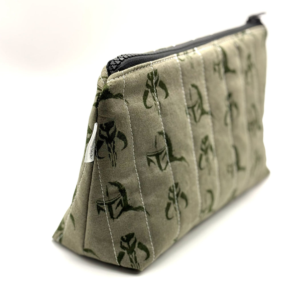 Zipper pouch with a green Mandalorian mudhorn pattern on a tan background