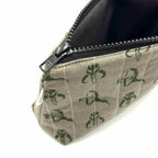 Zipper pouch with a green Mandalorian mudhorn pattern on a tan background