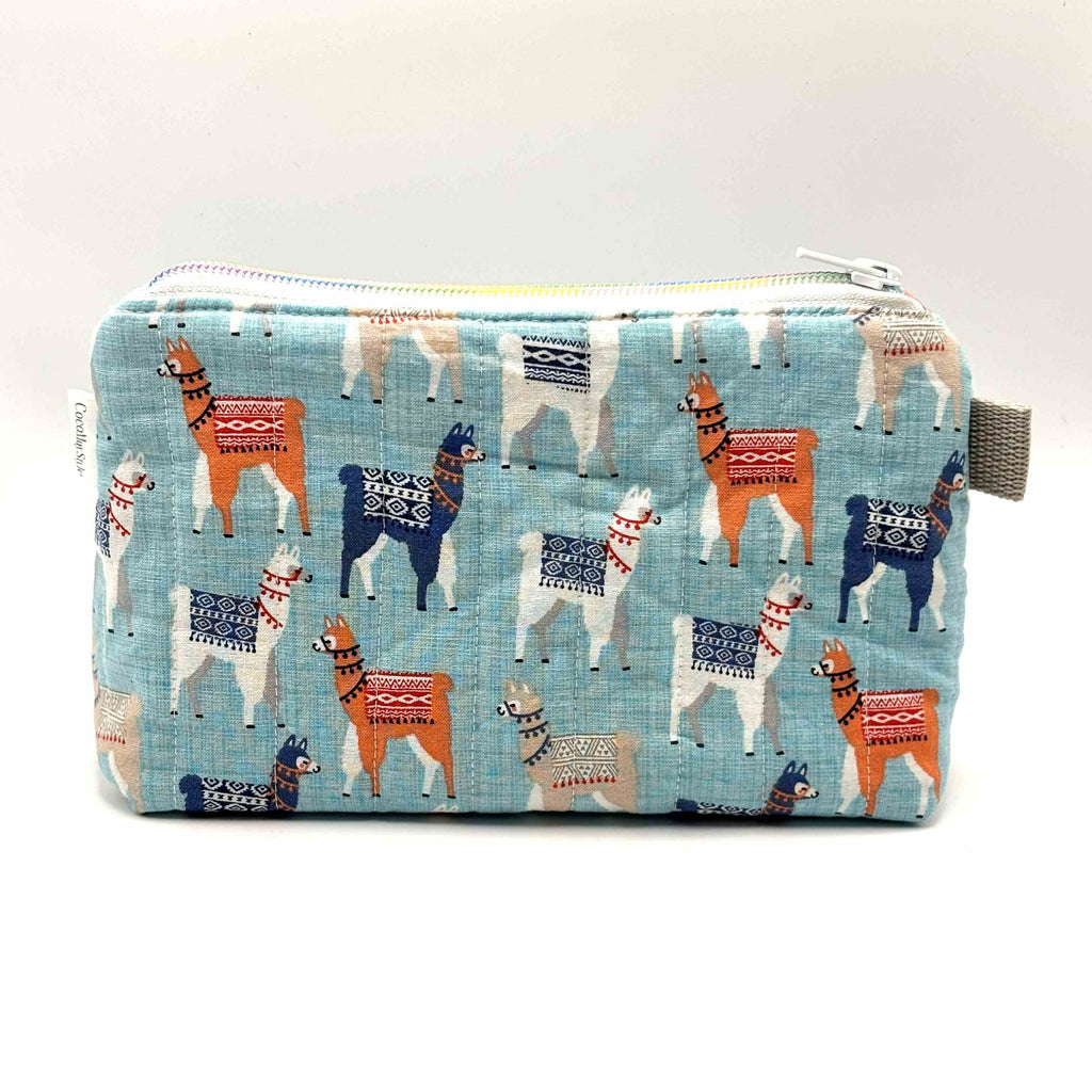 Zipper pouch with a llama pattern on a light blue background