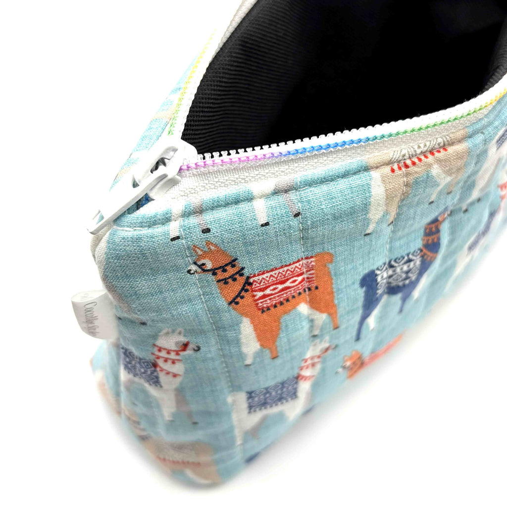 Zipper pouch with a llama pattern on a light blue background
