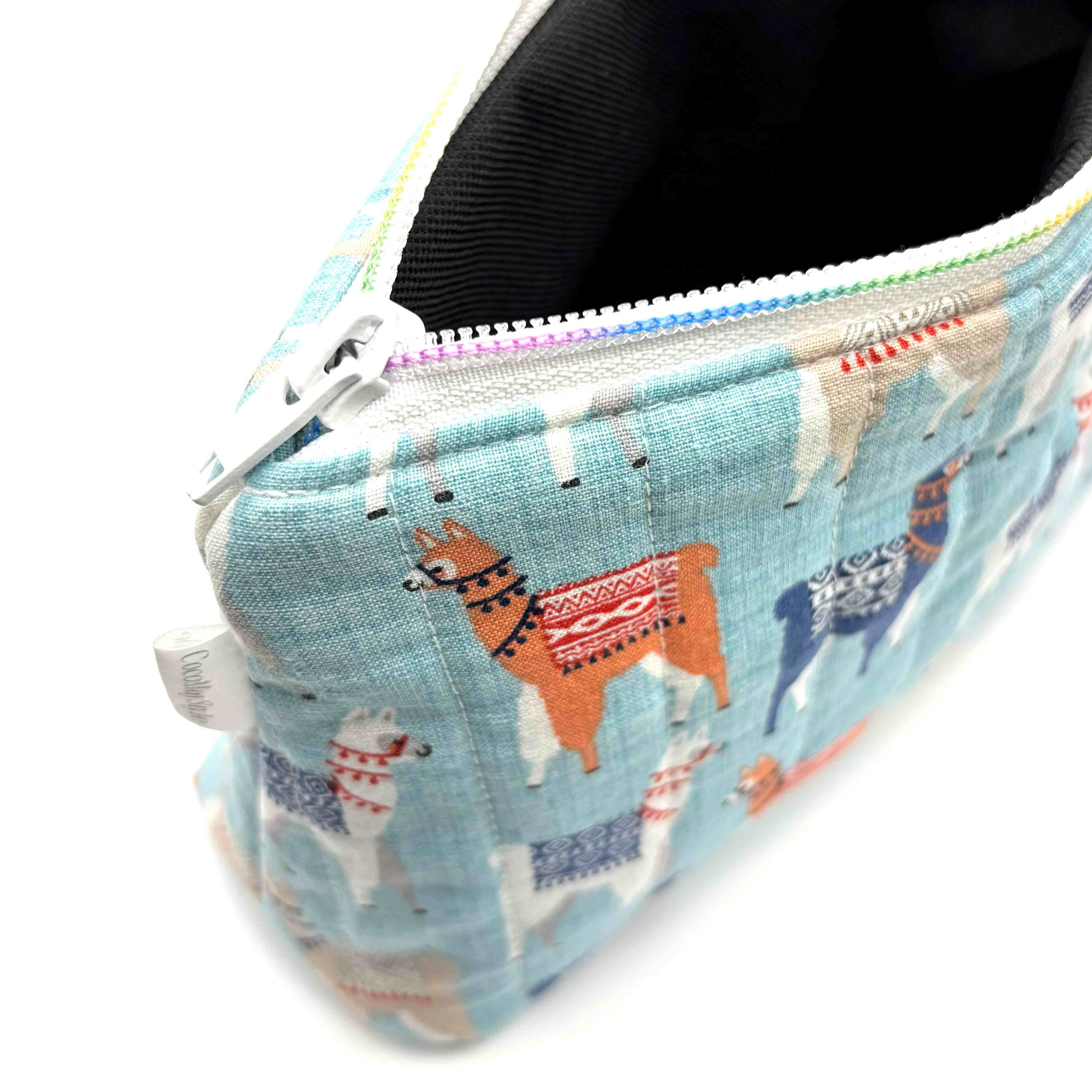 Zipper pouch with a llama pattern on a light blue background