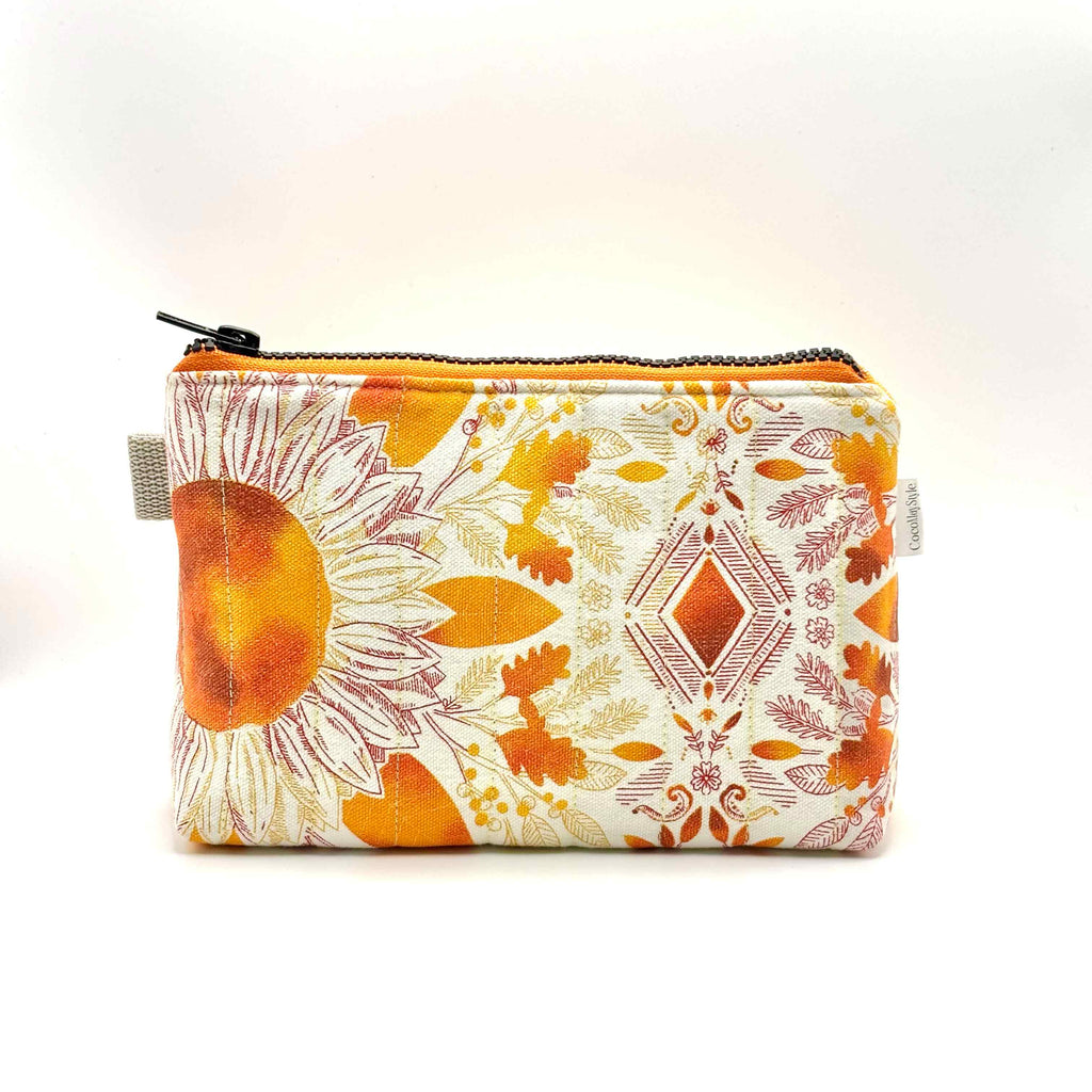 Zipper pouch with a pink, orange, and yellow floral pattern