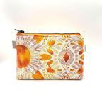 Zipper pouch with a pink, orange, and yellow floral pattern