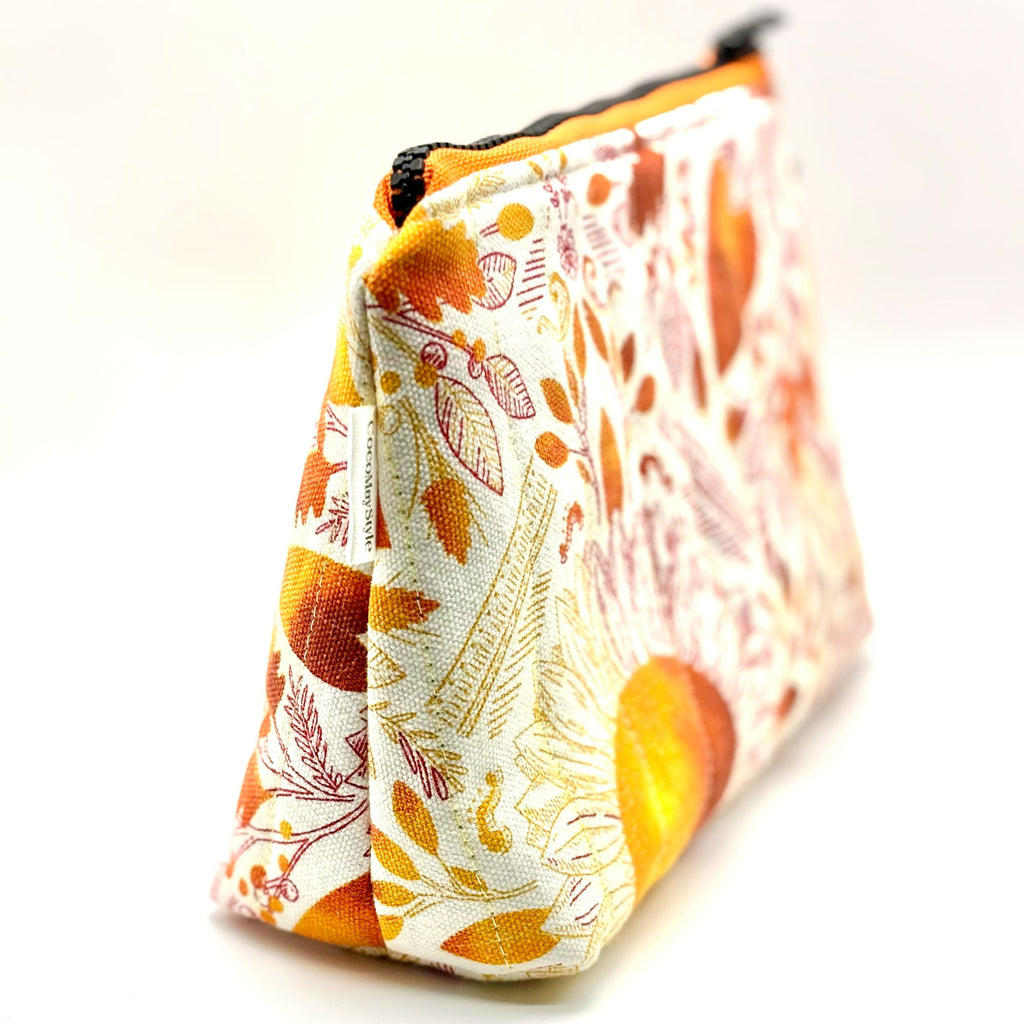 Zipper pouch with a pink, orange, and yellow floral pattern
